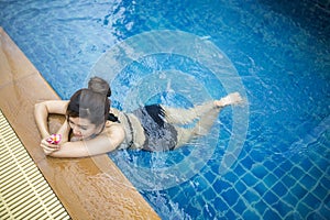 Beautiful woman relaxing on the swimming pool