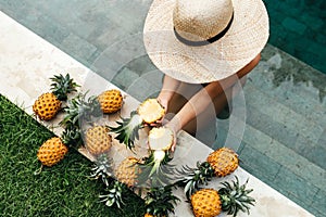 Beautiful Woman Relaxing In Swimming Pool With Pineapples. Healthy Lifestyle, Nutrition, Diet. Summer Vacation