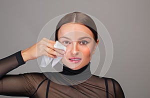 Beautiful woman removing makeup from her face. Beauty concept
