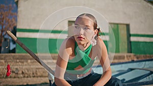 Beautiful woman resting riverside house closeup. Calm stylish girl sit in boat