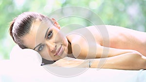 Beautiful woman is resting on spa bed