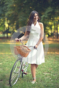 Beautiful woman riding bicylce in park and enjoying beautiful sunny day