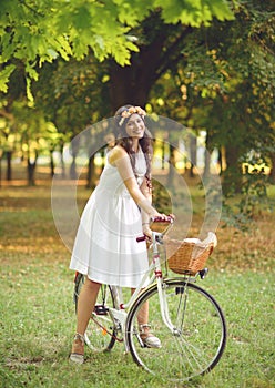 Beautiful woman riding bicylce in park and enjoying beautiful sunny day