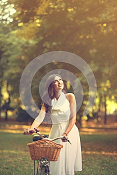 Beautiful woman riding bicylce in park and enjoying beautiful sunny day