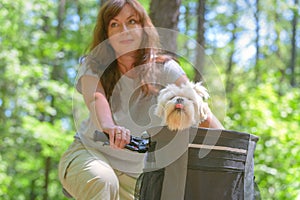 Beautiful  woman riding a bike with her dog