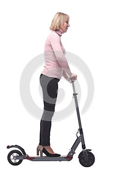 Beautiful woman riding an electric scooter isolated on white background