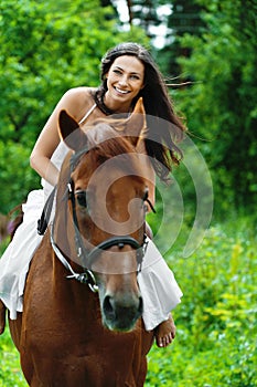 Beautiful woman riding horse