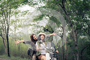 Beautiful woman riding a motor scooter on road. Travels by scooter with a friend slow life in the countryside.