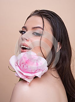 Beautiful woman with rose flower. Pink lips and rose. Beauty girl. Sensual sexy mouth.