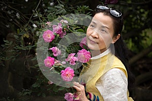 Beautiful woman in rose garden