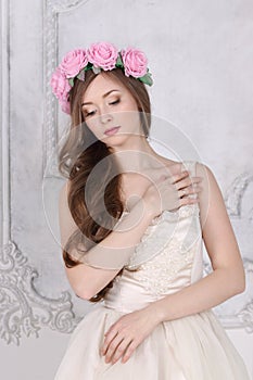 Beautiful woman in roses wreath with long hair