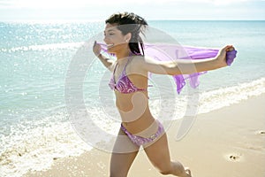 Beautiful woman running in bikini on the beach