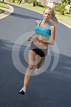 Beautiful Woman Running & Listening to MP3 Player photo