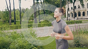 Beautiful woman running at morning jog while cardio training outdoor
