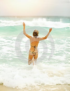 A beautiful woman running in the sea