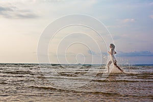 Beautiful woman running on the sea