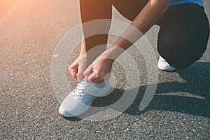 Beautiful woman running during sunset. Young fitness model near seaside. Dressed in sportswear. Cords sneakers