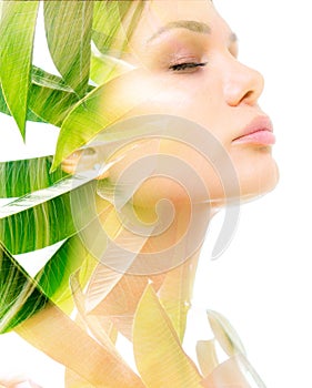 A beautiful woman`s double exposure profile portrait with eyes closed against white blackground