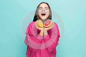 Beautiful woman`s face with juicy orange