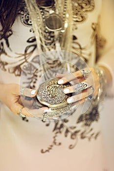 Beautiful woman`s hands holding vintage jewelry box, hand with perfect nail polish and silver rings