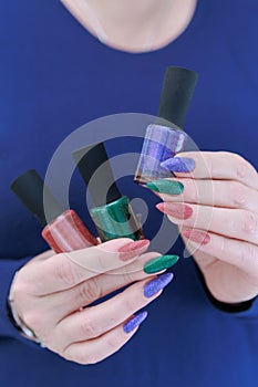 beautiful Woman's hands with long nails and multi-colored manicure