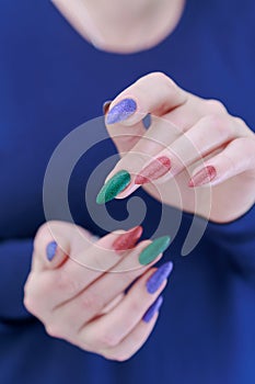 beautiful Woman\'s hands with long nails and multi-colored manicure