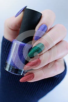 beautiful Woman\'s hands with long nails and multi-colored manicure