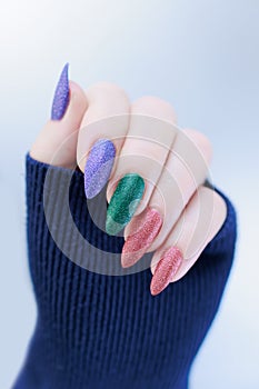 beautiful Woman\'s hands with long nails and multi-colored manicure