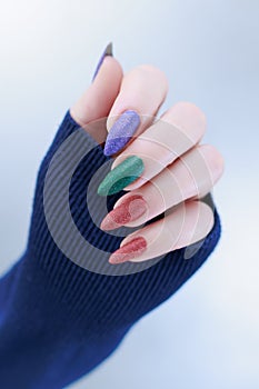 beautiful Woman\'s hands with long nails and multi-colored manicure