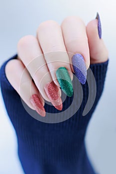 beautiful Woman\'s hands with long nails and multi-colored manicure