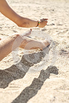 Beautiful woman`s legs on the beach