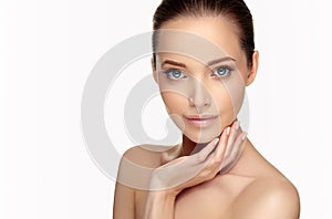 Beautiful woman s touching tenderly the cheek by graceful fingers of hand.Facial treatment and cosmetology.