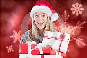 Beautiful woman in santa hat holding christmas gifts