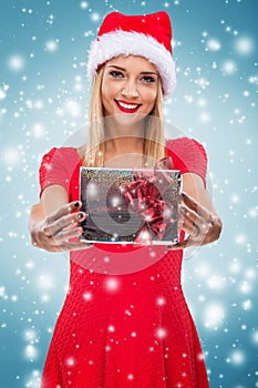 Beautiful woman with santa hat, holding two red gift box - snowfall