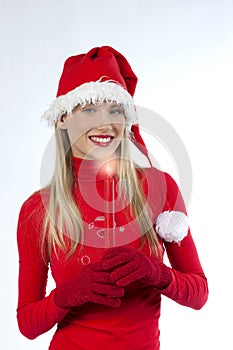 Beautiful woman in santa's hat holding a candle