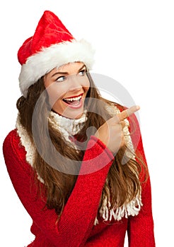 Beautiful woman in santahat pointing at copyspace