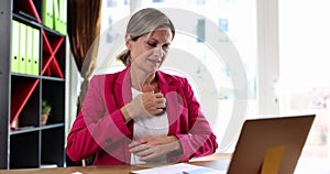 Beautiful woman scratching hand and body at workplace