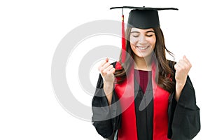 Beautiful woman screaming with happiness while graduating