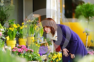 Beautiful woman selecting flowers at flower market