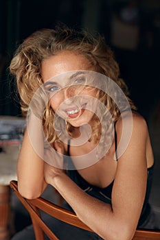 Beautiful Woman. Sexy Blonde Model Relaxing On Wooden Chair. Healthy Natural Look In Beauty Portrait.