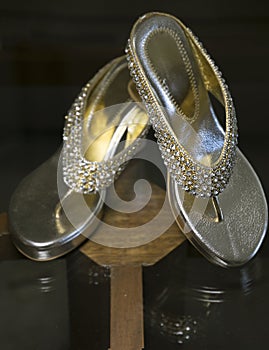 Beautiful Woman shinning sandals on a glass table