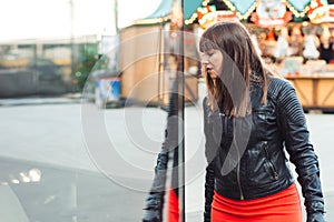 Beautiful woman with shopping bags looking at the shop window