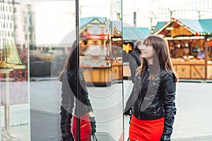 Beautiful woman with shopping bags looking at the shop window