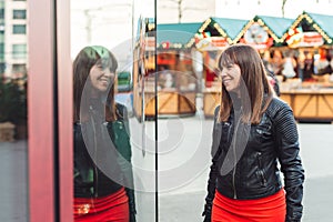 Beautiful woman with shopping bags looking at the shop window