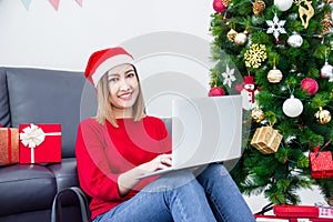 Beautiful  woman shopping online via computer on Christmas day