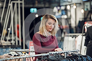 Beautiful woman shopping for some clothes at a store