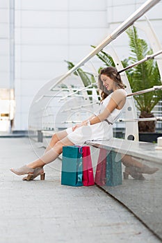 Beautiful woman shopping in the summer city