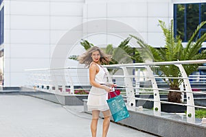 Beautiful woman shopping in the summer city