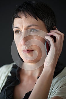 Beautiful Woman with Short Brown Hair Talking on a Cell Phone