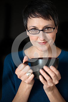 Beautiful Woman with Short Hair and Coffee Cup on Black Background